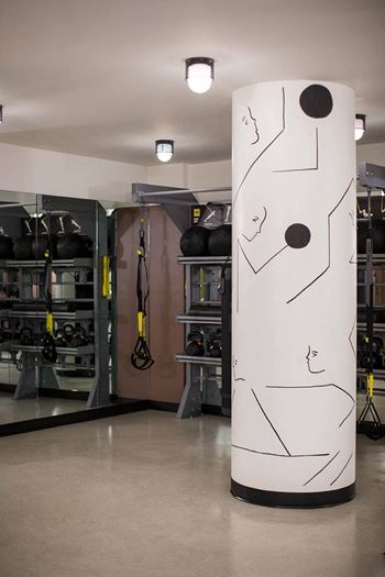 a large white column with a face on it in a garage at The Flat, California